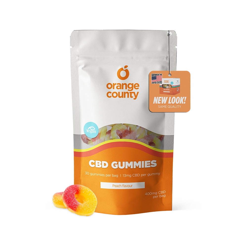 Orange County CBD Gummies pouch in peach flavor, shown on a white background with two gummy candies in front and a promotional hang tag.