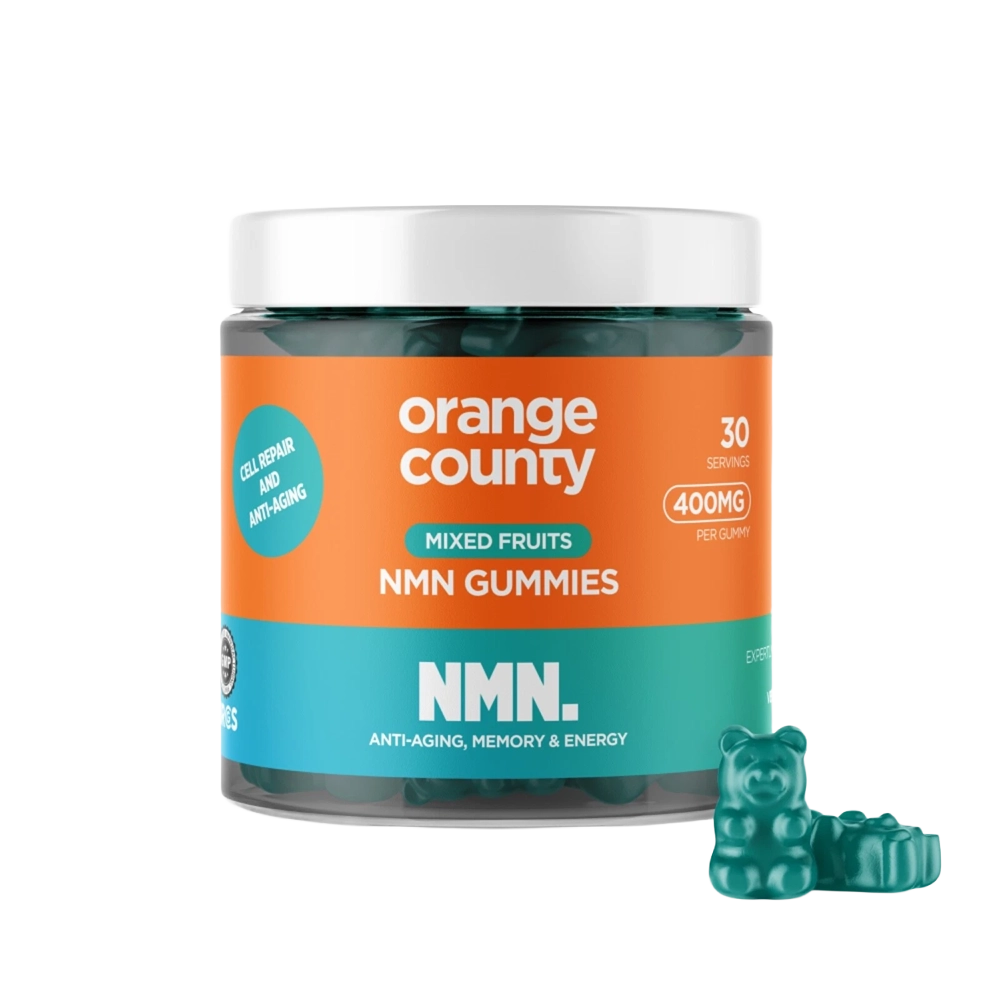 A jar of Orange County NMN Gummies for mixed fruits, featuring a bright orange and teal label with a white lid, shown alongside three green gummy bear candies on a white background.