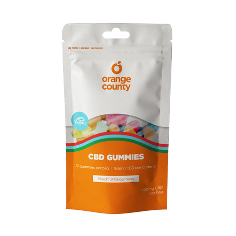 A stand-up pouch of Orange County CBD Gummies on a plain white background. The packaging is white on the top half and bright orange on the bottom, with a clear window showing multicolored gummies inside.