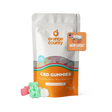 An orange and white stand-up pouch of Orange County CBD Gummies with a clear window showing multicolored gummies inside, plus three loose gummies in front on a white background.