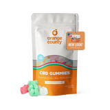 An orange and white stand-up pouch of Orange County CBD Gummies with a clear window showing multicolored gummies inside, plus three loose gummies in front on a white background.