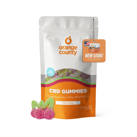 An orange and white stand-up pouch of Orange County CBD Gummies, Cherry flavour, with three individual pink and green gummies displayed in front on a clean white background.