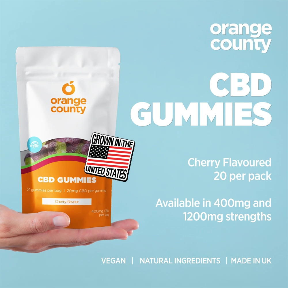 Orange County CBD Gummies packaging held by a hand with product details on a blue background
