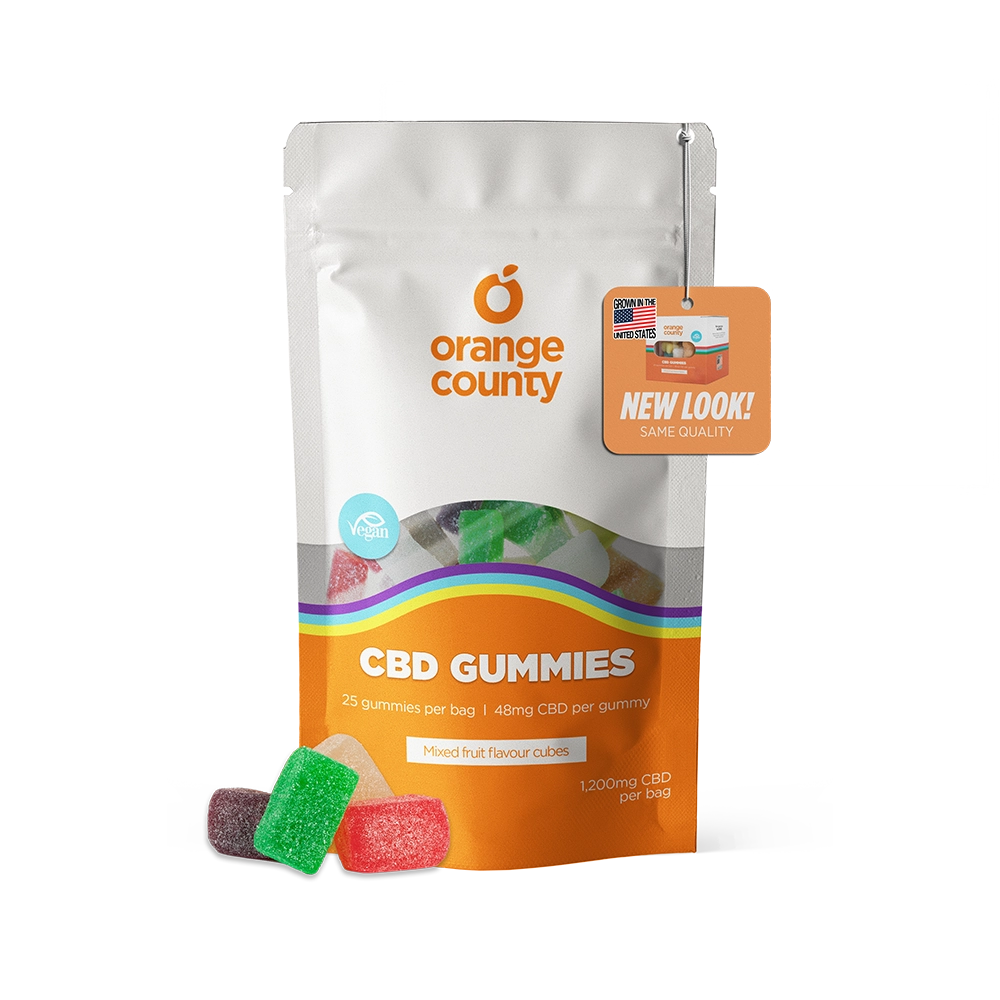 An orange and white stand-up pouch of Orange County CBD Gummies with a clear window showing multicolored gummies inside, plus three loose gummies in front on a white background.