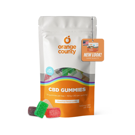 An orange and white stand-up pouch of Orange County CBD Gummies with several colorful gummy candies displayed in front on a white background.