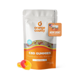 An orange and white stand-up pouch of Orange County CBD Gummies with a 'New Look! Same Quality' hang tag, shown on a white background with two gummy candies in front.