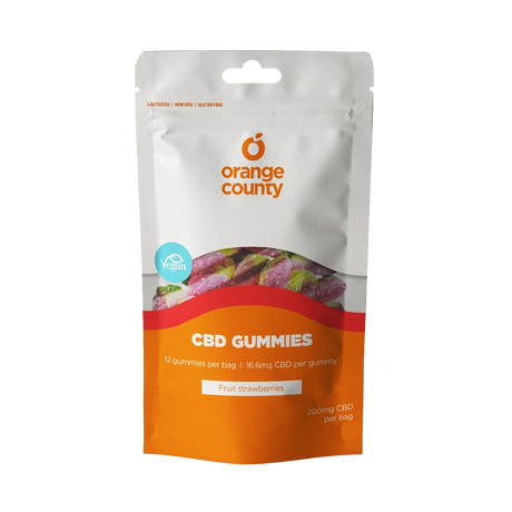 An orange and white stand-up pouch of Orange County CBD Gummies, Fruit Strawberries flavor, on a solid white background.