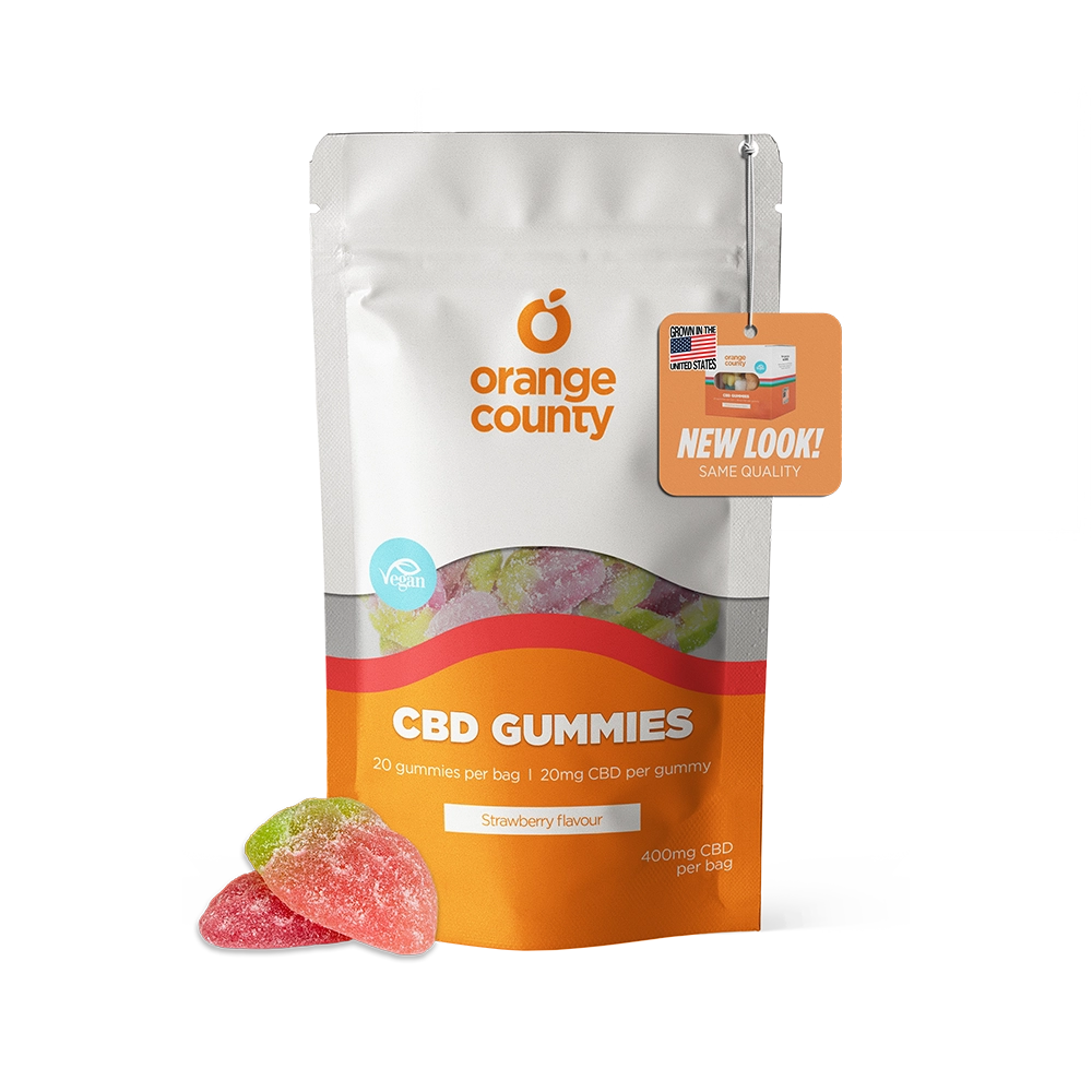 A stand-up pouch of Orange County CBD Gummies in strawberry flavor, shown on a clean white background with three gummy candies placed in front. The packaging is white and orange with a clear window revealing multicolored gummies inside, and an orange hang tag reading 'NEW LOOK! SAME QUALITY.