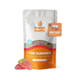 A stand-up pouch of Orange County CBD Gummies in strawberry flavor, shown on a clean white background with three gummy candies placed in front. The packaging is white and orange with a clear window revealing multicolored gummies inside, and an orange hang tag reading 'NEW LOOK! SAME QUALITY.