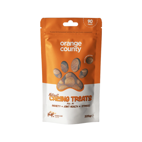 A 225g stand-up pouch of Natural Calming Treats for dogs by Orange County, featuring an orange and white design with a paw print window showing the treats inside.