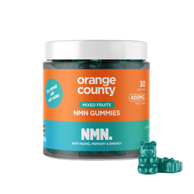 A jar of Orange County NMN Gummies for mixed fruits, featuring a bright orange and teal label with a white lid, shown alongside three green gummy bear candies on a white background.
