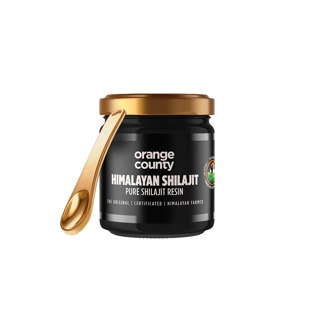A jar of Orange County Himalayan Shilajit resin with a black body, gold lid, and a gold spoon resting against the jar, shown on a plain white background.